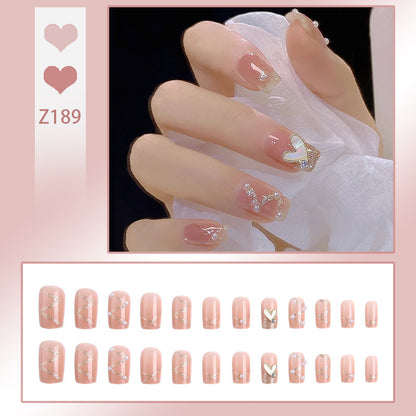 Nail art set with elegant wave patterns and delicate pearl accents Acalora