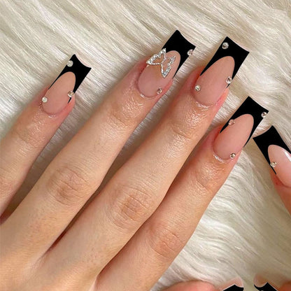 Acrylic nail set with elegant black and white design and glitter accents Acalora