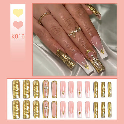 Acrylic nail set with elegant golden embellishments and glamorous accents Acalora