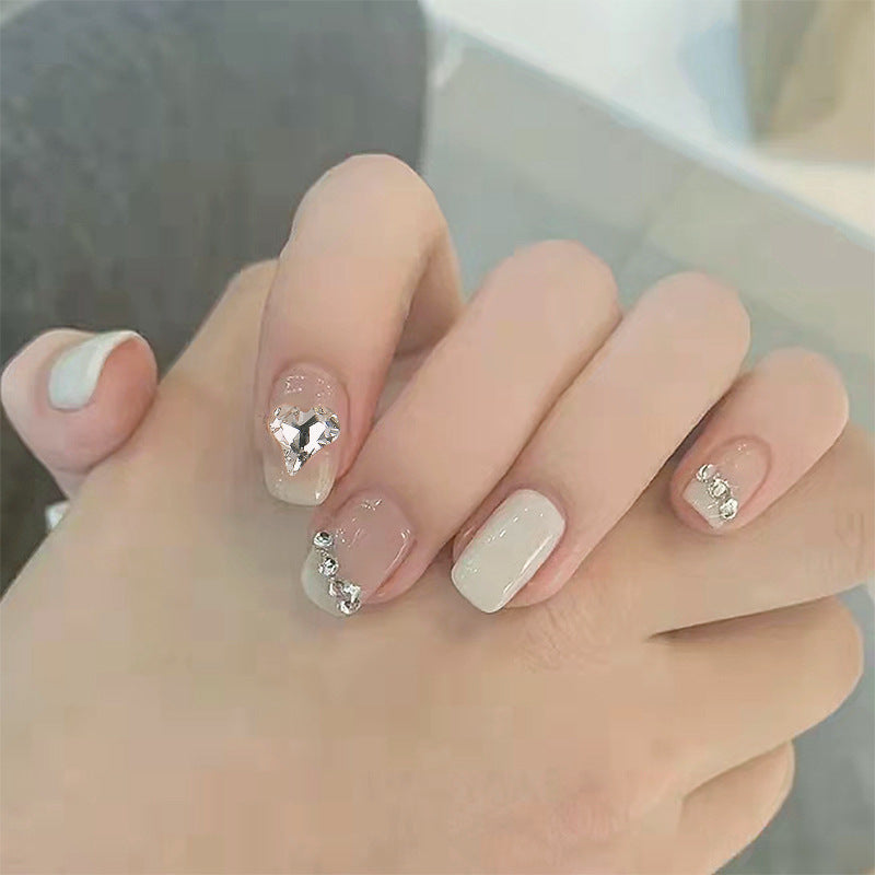 Glamorous artificial nails with heart and rhinestone decorations Acalora