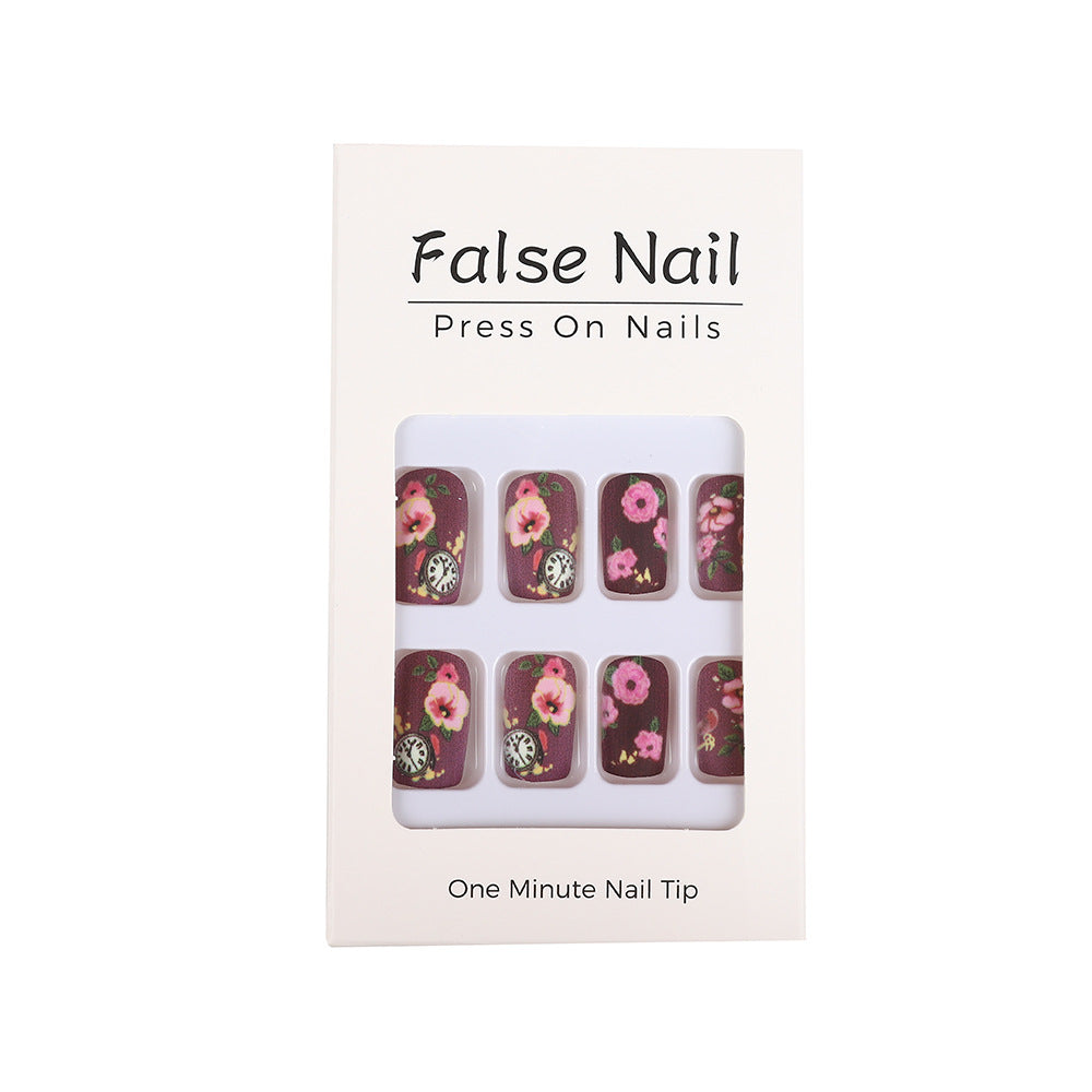 Nail art with floral design and intricate clock motifs Acalora
