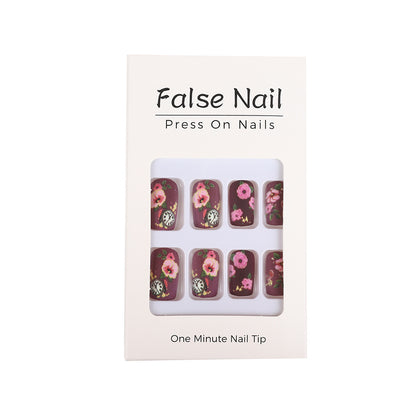 Nail art with floral design and intricate clock motifs Acalora