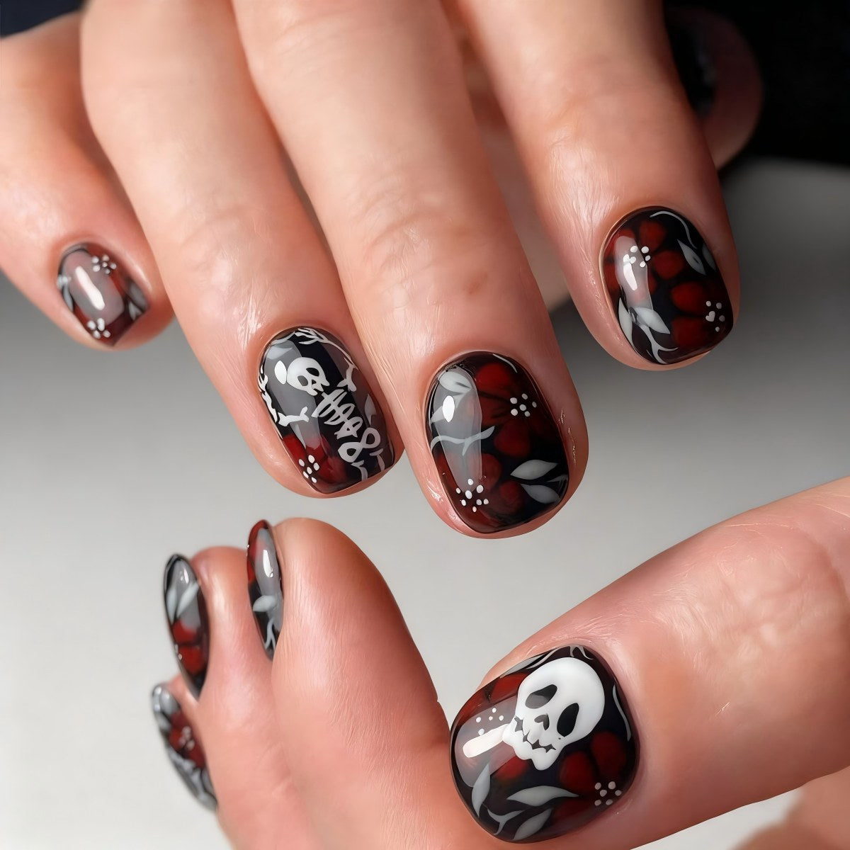 Artificial nail set with creepy skull design and floral accents Acalora