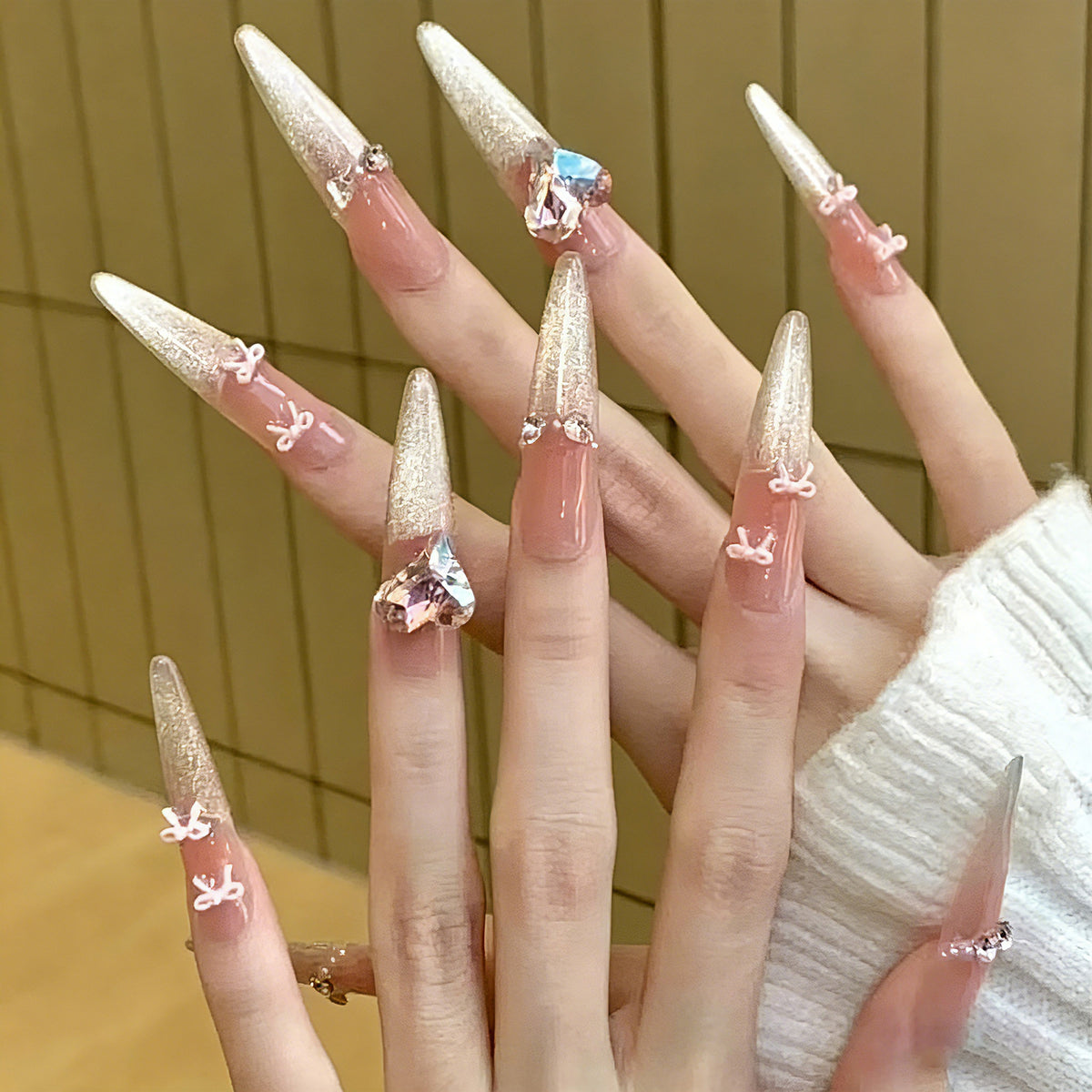 Art nail set with sparkling tips and delicate bow decorations Acalora