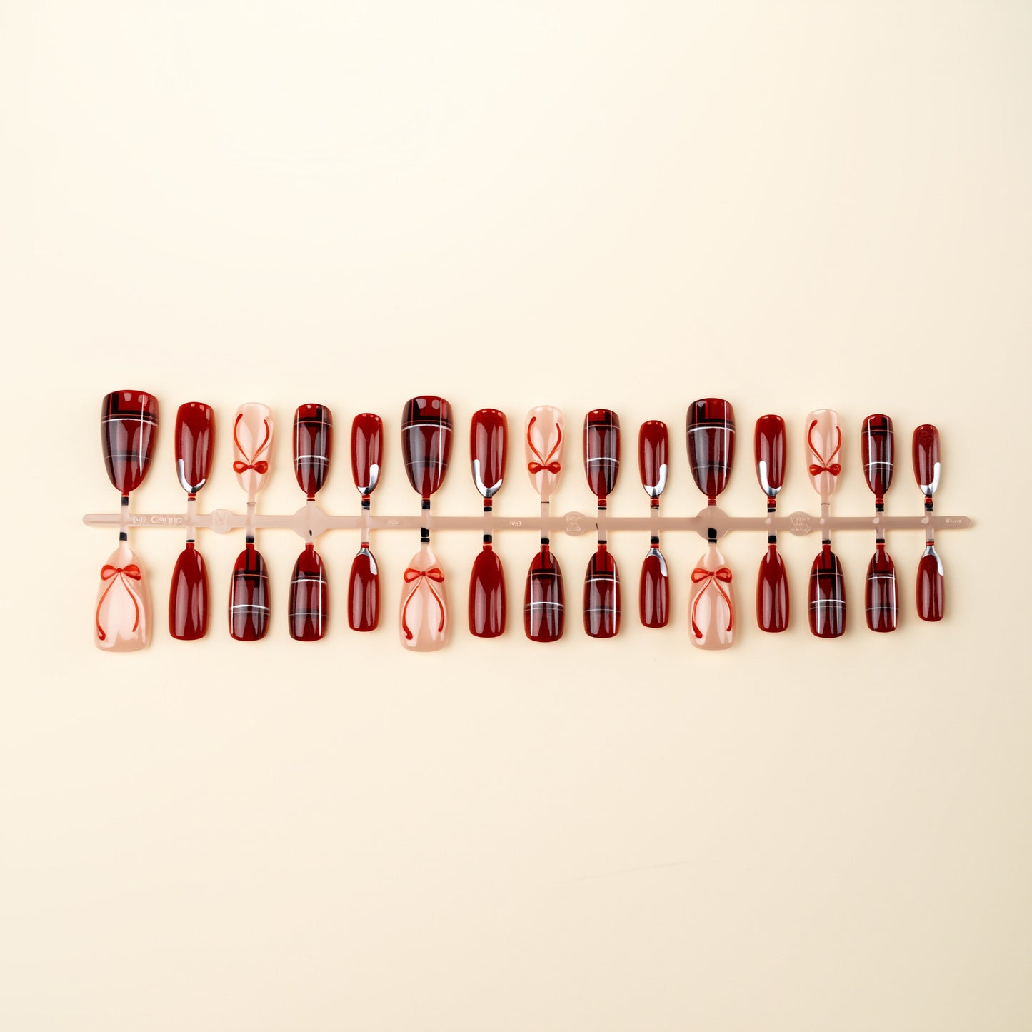 Art nail set with festive design and bow accents Acalora