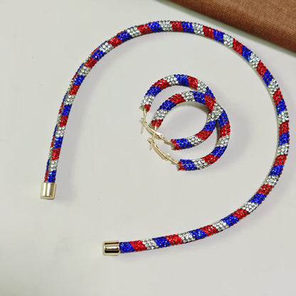 Women's handcrafted crystal pavé hoop earrings with curved tube element and clasp closure Bowlift