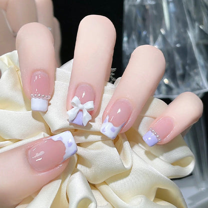 Nail art set with elegant wave patterns and delicate pearl accents Acalora