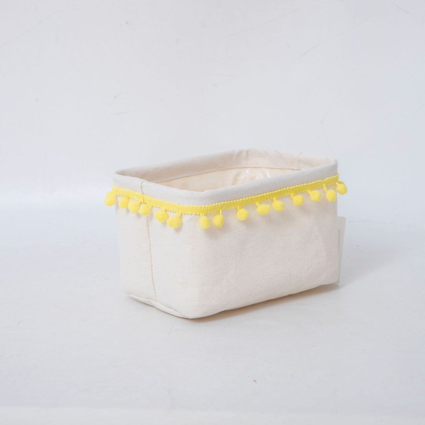 Storage basket with decorative pom-pom trim