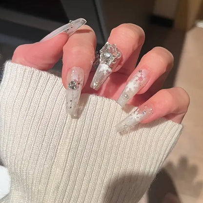Artificial nail set with frosty snowflake design and sparkling 3D applications Acalora