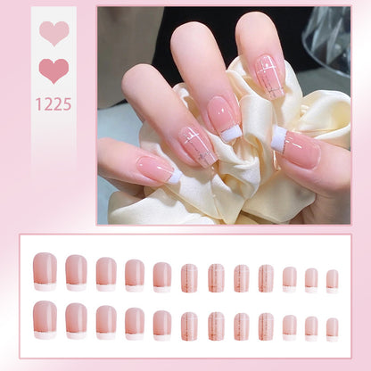Nail set with elegant French tip and fashionable embellishments Acalora