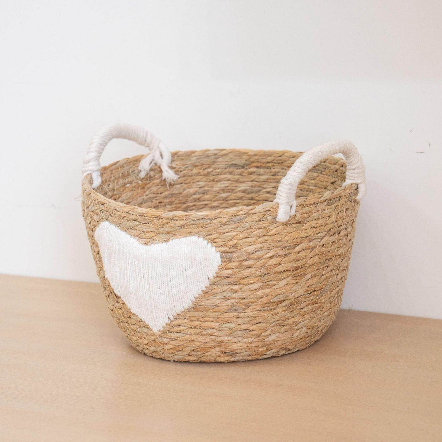 Handwoven storage basket with heart design Acalora