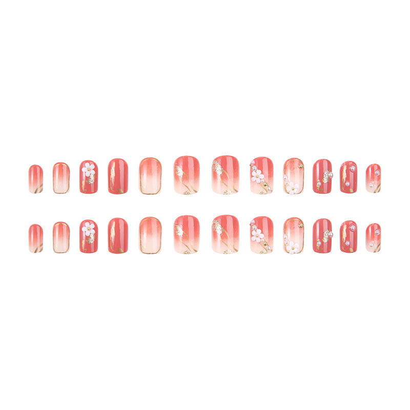 Acrylic nail set with elegant floral decorations and glamorous pearl accents Acalora