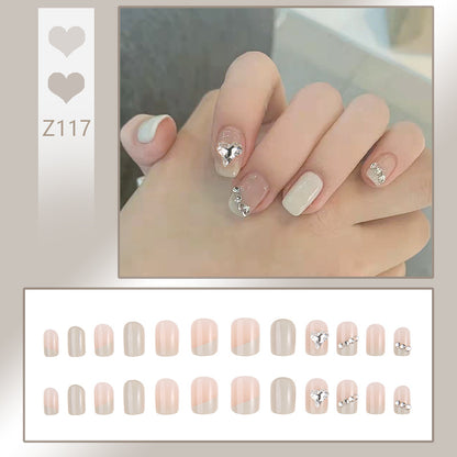Glamorous artificial nails with heart and rhinestone decorations Acalora