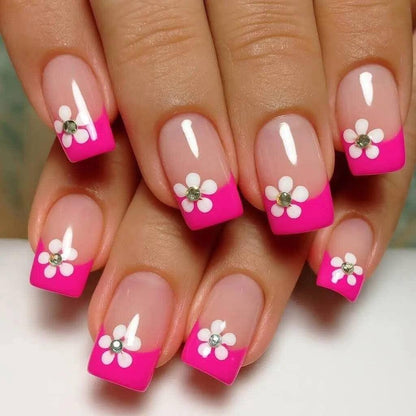Artificial nails in a playful flower design with glittering accents Acalora