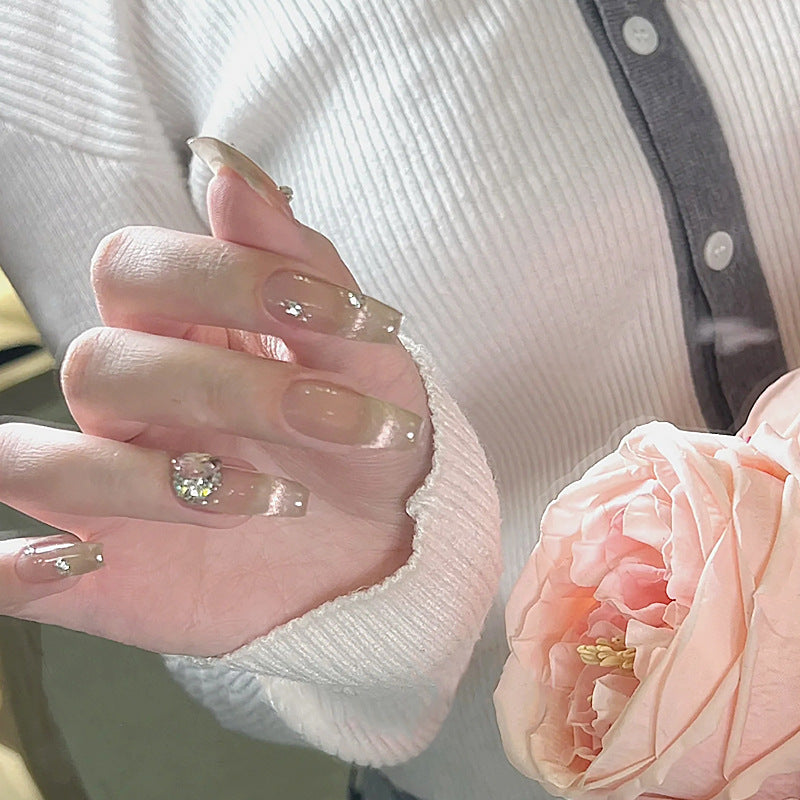 Acrylic nail set with glamorous glitter accents and elegant jewelry embellishments Acalora