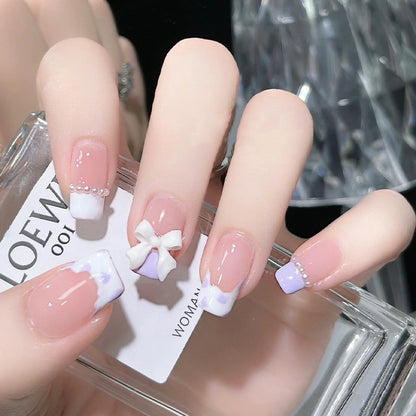 Nail art set with elegant wave patterns and delicate pearl accents Acalora