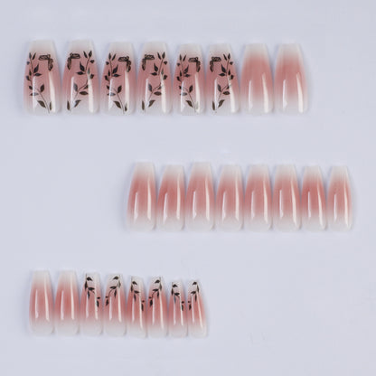 Press-on nails in elegant ombre design with floral accents Acalora