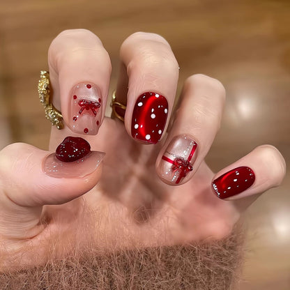 Artificial nail set with festive gift design and elegant glitter accents Acalora