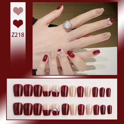 Glamorous artificial nails with glitter and pearl decorations Acalora