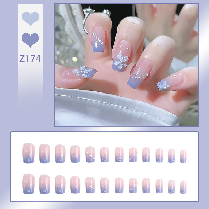 Nail set with elegant floral accents and glitter embellishments Acalora