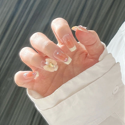 Artificial nail set with elegant floral decorations and glitter accents Acalora