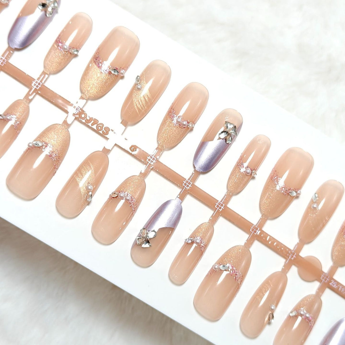 Artificial nails with modern glitter and stone embellishments Acalora
