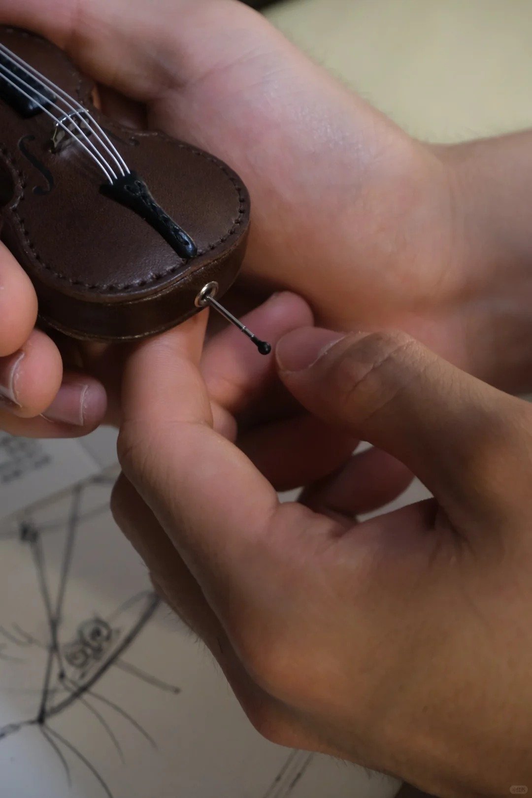Crafted leather keychain with violin and cello