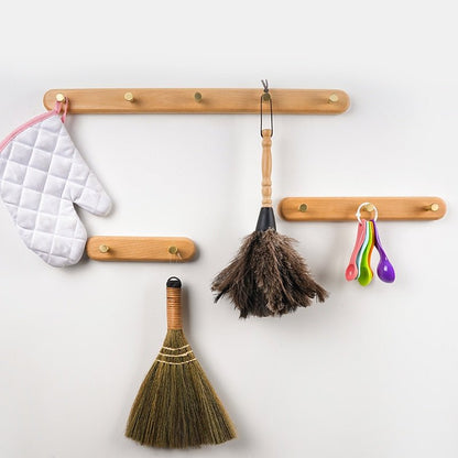 BowLift | WandHout – Minimalistic wooden wall coat rack with brass hooks