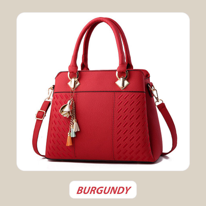 Elegant women's handbag with tassel charm