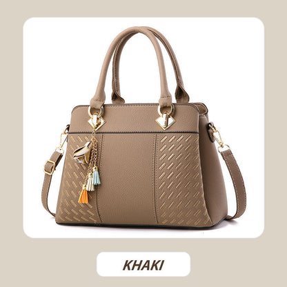 Elegant women's handbag with tassel charm